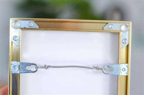 metal brackets with holes in picture frames|picture hangers for metal frame.